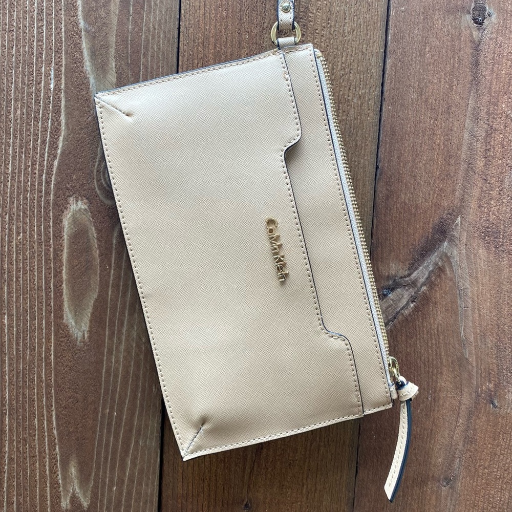 Calvin Klein wristlet; cream with gold logo